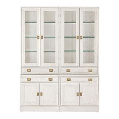 a white china cabinet with glass doors and gold hardware on the bottom, against a white background