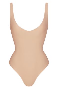 This plunging bodysuit that accentuates your curves is designed to wear along with your favorite bottoms or underneath closet essentials. It features unlined cups to flatter your bust, convertible straps you can wear cross-back style and a snap gusset. V-neck Convertible, adjustable straps Thong back Cotton-lined gusset with snap closure 76% cotton, 24% spandex Machine wash, tumble dry Imported High Cut Seamless Summer Leotard, Fitted V-neck Lined Body Shapewear, Chic Seamless Second-skin Bodysuit, High Cut Smoothing Leotard For Summer, Summer High Cut Smoothing Leotard, Backless Elastane Bodysuit With Smoothing Details, Chic Stretch Shapewear With Lined Body, Summer Smoothing Backless Bodysuit, High Cut Summer Bodysuit With Moderate Back Coverage