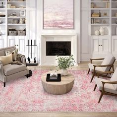 a living room filled with furniture and a large painting on the wall above it's fireplace