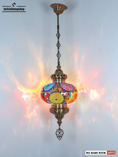 a chandelier hanging from a ceiling with colorful lights in the background