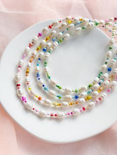 "Freshwater pearls are naturally unique in colour, texture, and shape so your pearls will differ from those shown in the photos. The mixed beads are also random so your necklace strand will not be exactly the same as the examples shown in the photos and will be completely unique.  ∙ A P P R O X∙ M E A S U R E M E N T S ∙ 15\" + 2\" extension chain (17\" total).  Please message us for a custom listing if you would like a longer length (£2 per additional inch).  ∙ M A T E R I A L S ∙  Strong durab Handmade Multicolor Pearl Necklace, Pearl White Necklaces With Beaded Chain, White Necklace With Tiny Oval Beads, Pearl White Necklaces With Beaded Chain And Round Beads, Adjustable Pearl White Beaded Necklaces, Adjustable Pearl White Beaded Necklaces With Round Beads, Pearl Necklaces With Oval Beaded Details, Handmade Multicolor Pearl Beaded Bracelets, White Oval Beaded Necklace