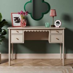 a desk with two drawers and a mirror on the wall next to potted plants