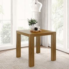 a wooden table sitting on top of a carpeted floor next to a white vase