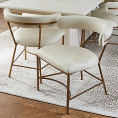 a dining room table with chairs and a rug on the floor