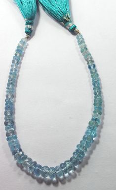 a necklace with blue beads and tassels