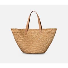 Market finds fit perfectly in this woven seagrass bag, with fully wrapped edges and durable leather straps. MeasurementsSmall: 22.5"L x 5.5"W x 12"HLarge: 23.5"L x 7"W x 14"HColor: Natural Seagrass Natural Bucket Bag With Intrecciato Weave, Everyday Jute Straw Bag With Bamboo Handle, Beige Basket Bag With Intrecciato Weave, Chic Basket Shoulder Bag With Intrecciato Weave, Everyday Jute Beach Bag With Bamboo Handle, Chic Rattan Bags With Woven Leather, Chic Woven Leather Basket Straw Bag, Beach Straw Bag With Intrecciato Weave, Natural Straw Bag With Intrecciato Weave