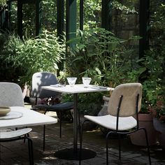 two chairs and a table in a garden