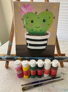 a cactus in a pot with paint and markers