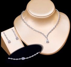 A beautiful three-piece bridal jewelry set that will add elegance and sophistication to any wedding gown or formal ensemble! Adorned with intricately faceted cubic zirconia that capture the light from every angle with a perfectly translucent appeal, the pieces are platinum plated for a flawless finish which enhances the intricate detailing and conveys a modern take on old elegance. Necklace: 17" (approx. 43cm) long with a secure fold-over closure (a 2" extension chain can be added upon request, Beautiful Diamond Earrings, Silver Wedding Jewelry, Bridal Jewelry Set, Bridal Jewelry Sets, Three Piece, Wedding Gown, Jewelry Set, Bridal Jewelry, Wedding Jewelry