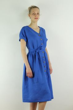 "Spring dress, Write the selected color in the message Handmade indigo color linen dress with short sleeves and 2 pockets , perfect for casual wear and suitable for any occasion in any season Details: - 100% natural linen produced in Europe ; - medium weight (180 gram per square meter); - color:indigo linen, could be any from our colors catalog (color samples at the photo); Made to order, approximately a few days, If you have any questions please message me and I will be glad to answer. Size gui Summer Indigo Dresses With Buttons, Casual Indigo Dress With Buttons, Summer Dresses With Short Sleeves And Buttons, V-neck Linen Dress With Pockets, Short Sleeve Midi Dress With Pockets For Vacation, Casual Short Sleeve Blue Cotton Dress, Short Sleeve Midi Dress With Pockets For Beach, Blue Relaxed Fit Linen Summer Dress, Casual Blue Linen Dress