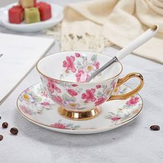 a tea cup and saucer with a spoon in it