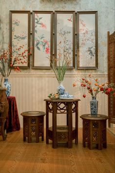 three tables with vases and flowers on them