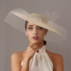 Elegant Cream wedding hat with veil. The cream hat is wrapped with crystals veil that ends in a bow.  This ivory hat is perfect for any special occasion, Tea Party, Derby, races or wedding. It is mounted on a headband that allows to tilt the sunhat to the liking of each one. Any color headdress can be changed to order. The sunhats are ship by courier to all countries. 1€ of each Order will be donated to Cancer Research. Destinations              Processing time                     Delivery time Derby Day Outfits For Women, Brides Veil, Royal Blue Fascinator, Veil Hat, Race Day Hats, Hat With Veil, Hat Cream, Tea Hats, Royal Ascot Hats