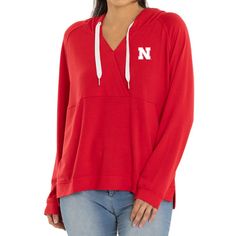 Top off any Nebraska Huskers look with this Christine Cross Front Tri-Blend Pullover Hoodie. It features team graphics and a unique cross front design. Tailgating before the game or cheering in the stands, show school spirit with this Nebraska Huskers hoodie. Hooded Tops With Team Logo For Fans, Hooded Tops With Team Logo For Fan Gear, Team-colored Hooded Top For Fan Gear, Team-colored Hooded Top For Game Day, Team-colored Hooded Tops With Team Logo, Game Day Fan Apparel Tops With Drawstring Hood, Collegiate Hooded Tops For Game Day, Team Spirit Long Sleeve Tops With Drawstring Hood, Fan Apparel Tops With Drawstring Hood For Sports Events