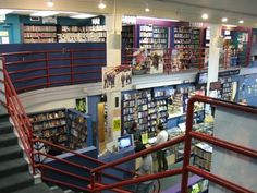 the inside of a bookstore with stairs and bookshelves