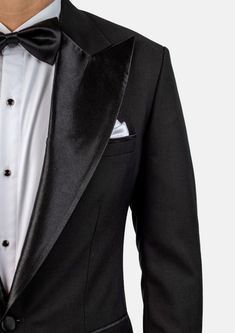 Crafted from a luxurious sharkskin weave wool, the Liberty Black Tuxedo is a sophisticated, statement-making formalwear option. Wide peak lapels in a single button configuration stand out from typical tuxedo styles. Dress to impress with this high-end, premium garment – a modern blend of elegance and refinement. Tuxedo Suits For Black-tie Gala Events, Elegant Black Double Breasted Suit With Hidden Buttons, Luxury Black Suits For Gala Events, Luxury Evening Blazer With Lapel Collar, Fitted Black Blazer For Gala, Luxury Single Breasted Evening Blazer, Tailored Tuxedo With Notch Lapel, Tailored Notch Lapel Tuxedo, Evening Suits With Notch Lapel And Pressed Crease