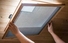 a person is working on a window in a cabin