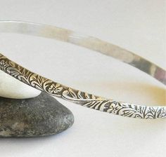 "A lovely vintage-look sterling silver bangle in a beautiful floral pattern. 4mm wide, a nice size to wear alone or stacked with your other bangles. Sterling silver bangles are a timeless accessory. They are so easy and comfortable to wear. Handmade by me, gently work-hardening the wire into a round shape, soldering the wire ends, oxidizing and finally, hand-polishing to a high shine. The seam where the two ends of the patterned wire meet will be visible on the inside surface of the bracelet, bu Rodeo Jewelry, Petite Earrings, Simple Bangle, Bangle Silver, Silver Bangle Bracelet, Sterling Silver Bangle Bracelets, Vintage Bangles, Sterling Silver Bangle, Simple Bracelets