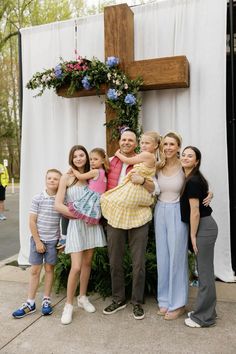 a group of people standing in front of a cross