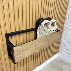 a pair of shoes that are sitting in a shoe rack on the side of a wall