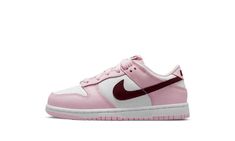 The Nike Dunk Low PS “Pink Foam” is the preschool sizing of the retro basketball shoe with eye-catching pink accents.  The “Pink Foam” turns head with a white leather base contrasted with Pink Foam leather overlays.  The look is broken up with Dark-Beetroot-colored leather Swoosh logos on both sides.  A Dark Beetroot “Nike” logo appears on the heel and is printed on the tongue tag above a dark red Swoosh.  The white midsole is paired with a pink rubber outsole. Dunks Brown, Low Dunks, Retro Basketball Shoes, Retro Basketball, Nike Basketball Shoes, Stadium Goods, Nike Kids, Nike Basketball, Pink Accents