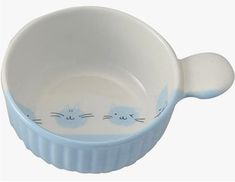 a blue and white bowl with two cats on it