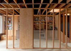 an unfinished room with wooden partitions in the center and shelves on the other side