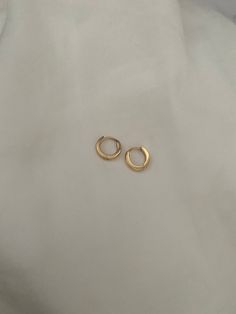 Brand new  *These are for a pair of mini hoops that may be able to fit for seconds and thirds too! They are very small and ear pin needs to be pushed down to click into place when you put them in! COLOURGold SIZE0.9x0.95cm 0.7cm inner Diameter MaterialGold Stainless Steel  Weight4 g Perfect for sensitive ears! Water friendly and tarnish resistant 💌Price includes free untracked shipping within Australia Tiny Gold Huggie Earrings Simple Style, Simple Gold Cartilage Earrings For Everyday, Simple Tiny Gold Huggie Earrings, Simple Tiny Hoop Huggie Earrings, Simple Tiny Huggie Hoop Earrings, Tiny 14k Gold Filled Hoop Earrings, Small Yellow Gold Hoop Earrings, Simple Small Hoop Tarnish Resistant Huggie Earrings, Tiny Hoop Huggie Earrings For Everyday