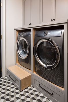 a washer and dryer in a room with black and white checkered flooring