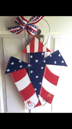 a patriotic door hanger hanging on the side of a door with an american flag design