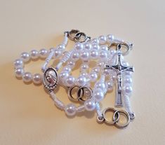 This beautiful rosary it's perfect gift for wedding. It's made with white resist cord and beautiful white pearl. In every decade is two rings what symbolizes weddings. Its made with medal Virgin Mary and cross MIR, MIR, MIR ( PEACE, PEACE, PEACE). Its come in beautiful white organza bag whit Message card of Our Lady of Medjugorje. If you have anny special wishes send me a note. If you want to brighten up someone's wedding day and give them a personal gift, you can order a wedding rosary with a n Spiritual Pearl Rosary Bracelet For Wedding, White Pearl Rosary As A Gift, Pearl Rosary Bracelet For Weddings, White Pearl Rosary As Gift, Adjustable White Rosary For First Communion, Elegant Adjustable Rosary For Baptism, Adjustable Elegant Rosary For Baptism, Pearl White Rosary For First Communion, Pearl Rosary With 8mm Beads For Wedding