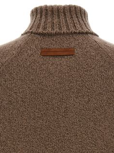 Boucle cashmere and silk sweater with high neck, long sleeves, suede patch. Composition: 80% ws 20% se Designer Brown Wool Sweater, Luxury Turtleneck Sweater For Fall, Classic Brown Funnel Neck Turtleneck, Designer Brown Sweater For Winter, Brown Merino Wool Turtleneck For Winter, Classic Brown Cashmere Turtleneck, Luxury Brown Wool Sweater, Brown Cashmere Long Sleeve Turtleneck, Designer Brown Sweater For Fall