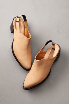 A transitional pair of shoes, the Delilah cowhide leather mules are perfect for the time of year when it's just a bit too early in the season to start wearing sandals. Handcrafted of buttery soft nubuck, these mules' western influences can be seen in the sophisticated almond toe and shaped heel. Wear them with jeans for a casual look or with a pair of flowy dress for a look that's sure to impress. Suede Slip-on Mules With Wooden Heel, Beige Leather Mules, Beige Leather Mules With Leather Footbed, Fall Closed Toe Mules With Leather Footbed, Fall Leather Footbed Closed Toe Mules, Beige Leather Mules With Rubber Sole, Summer Leather Clogs With Pointed Toe, Suede Mules With Stacked Heel And Almond Toe, Leather Closed Toe Mules For Fall