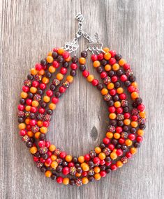 A beautiful sparkly beaded multi strand statement necklace made with orange, brown and red faceted and smooth acrylic and rhinestone beads. Perfect for Fall! Available for a limited time. - Shortest strand measures 19 - 21" long (length can be customized and varies depending on the clasp) - 5 Strands (more are listed)- 10mm beads- Stainless steel lobster claw clasp (sterling silver, gold filled and gold stainless steel also available)- Stainless steel 2" extender chain- Lead free pewter connecto Orange Multi-strand Colorful Beads Jewelry, Orange Multi-strand Beaded Necklaces, Orange Multi-strand Beaded Necklace, Orange Multi-strand Polished Beaded Necklaces, Orange Multi-strand Beaded Necklace With Polished Beads, Orange Multi-strand Polished Beads Jewelry, Orange Multi-strand Beads As Gift, Orange Multi-strand Polished Beaded Necklace, Amber Multi-strand Beaded Necklaces For Jewelry Making