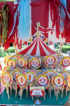 there are many lollipops on the table for sale at this carnival party