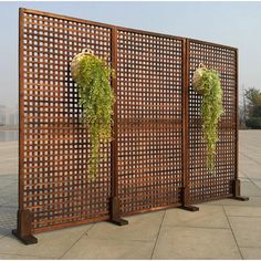 two wooden screens with plants growing out of them