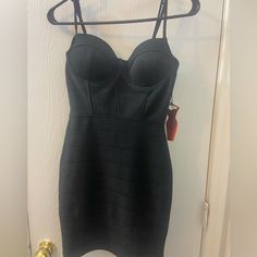 a black dress hanging up on a hanger