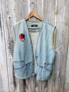 "SUUUUUCH a badass lil' vintage 90s vest!!  Customized and worn in to perfection, looks rad layered over a cute lil' dress with some tough boots, or lil' skinny jeans n' yer fave tee :) Details: * Vintage 90s * 100% Cotton denim vest * Length from front (when buttoned-from top of button to bottom of vest) 12\" * Length from back 24.5\" * Bust 21\"" Cheap 90s Style Vest For Spring, Cheap Retro Blue Denim Vest, Y2k Cotton Outerwear For Streetwear, Casual Denim Vest For Streetwear, Sleeveless Outerwear For Summer Streetwear, Spring Streetwear Cotton Vest, Spring Cotton Vest For Streetwear, Urban Style Denim Vest With Pockets For Spring, Sleeveless Summer Outerwear For Streetwear