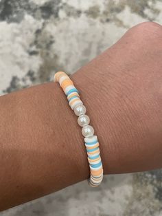 a person's arm with a bracelet on it