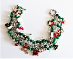 Beautiful Christmas charm bracelet designed with glass beads in the colors of green and clear. I have added Christmas charms to the design that have colorful detail. The chain is silver plated and nickel free. The beaded bracelet measures 8 inches in length which can be adjusted to the length you need. Just leave me a message in the notes of the order. This jewelry piece was designed and handmade by me and is a one of a kind item. This item will be shipped in a white jewelry box and colorful org Holiday Bracelets, Bracelet Christmas, White Jewelry Box, Bracelets Design, Christmas Bracelet, Crystal Lake, Christmas Gift For Her, Christmas Charms, Christmas Gift Jewelry