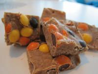 three pieces of candy bar sitting on top of a white plate with candy candies