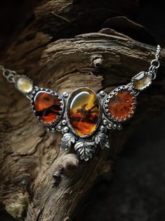 The Amber Dragon Heart is a gorgeous statement silver pendant necklace with unique Baltic amber and citrine gemstones. Its name was inspired by the inclusion seen in the amber in the center of the pendant, which resembles a dragon taking flight among orange clouds. The necklace is entirely handmade in sterling silver (.925) and fine silver (.999), sourced from a seller based in Krakow. Natural Baltic amber, handpicked in Gdansk (from a trusted seller) and faceted citrine gemstones from Jaipur. Adjustable chain 16'' - 18'' (40cm - 45cm) with a spring ring clasp. Free international tracked shipping. Did you know that amber is not a gemstone? It's a fossilized tree resin that dates back millions of years, often from ancient pine trees. Some amber pieces are over 100 million years old! Due to Amber Dragon, Amber Aesthetic, Pure Intentions, Orange Clouds, Dragon Heart, Hodge Podge, Gdansk, Citrine Gemstone, Amber Jewelry