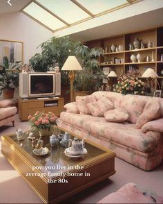 a living room filled with furniture and a flat screen tv sitting on top of a wooden coffee table