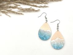 "Beach Themed Teardrop Earrings These beautiful acrylic beach-inspired earrings are perfect for summer. Grab a pair or two for that beach or cruise vacation. Excellent gift idea!  * These earrings are made of printed acrylic. Acrylic gives that minimalist feel, is lightweight, and comes with a bright vibrant print.  * The beachy design is printed on both sides * The teardrops are 2.25\" long, 1\" wide, and 1/8\" thick  * Hardware comes in either silver or gold plated. * Includes fishhook with rubber earring stoppers * All of our items are handcrafted in Topsail Nc We offer free shipping on all orders over $35! Follow our shop to get notifications of new designs and Sales!!  Looking for customized earrings for a special occasion or holiday, feel free to contact us." Ocean Earrings, Earrings Beach, Earrings Summer, Custom Earrings, Beach Themed, Beach Inspired, Cruise Vacation, Beach Sand, Beach Jewelry