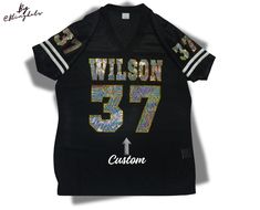 PLEASE READ BEFORE ORDERING: Personalize your Football Jersey. **All basic colors available **Shipping of this item takes 5 business days.  Includes Custom Team name and number on the front.   Player name and number on the back and sleeves **The iron on transfer option includes 1 design for the front. **Shirt is not included. 1️⃣✨Please let us know Team name and name and numbers  for the back After receiving your information and your order is placed, our specialized graphic design team will create a professional mockup and send it to you within 1-4 business days, with most cases being completed within 1 day. Please ensure that your Etsy messages notifications are turned on to avoid delays. 2️⃣ Shirt Description: Ladies regular fit **Please check size chart before ordering.  100% Polyester Bling Football Jersey, Customizable Fitted T-shirt For Sports Events, Custom Bling, Personalized Jersey, Spirit Shirts, Spirit Jersey, Game Jersey, Fan Shirts, Team Names