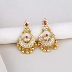 Add elegance and sophistication to your attire with this exquisite Silver Earring featuring a Semi Diamond Stone Chandhbali design. Made with 92.5 Silver and 24 kt gold plating, this stylish piece is adorned with semi-precious stones for a captivating look. Suitable for any occasion, from formal to casual. Height-48 mm width-32 mm   Note Product Care: To maintain the elegance of your silver jewelry, proper care is essential. Keep it away from sweat, water, and sleep to avoid tarnishing. Also, av Gold Dual-tone Chandbalis, Gold Kundan Chandelier Earrings With Dangling Beads, Gold Bollywood Chandelier Earrings With Dangling Beads, Gold Chandbalis With Dangling Beads For Wedding, Gold Chandbali Bridal Earrings With Dangling Beads, Elegant Gold Chandbalis With Dangling Beads, Elegant Gold Chandbalis For Reception, Gold Dual-tone Danglers, Gold Cutdana Dangle Danglers