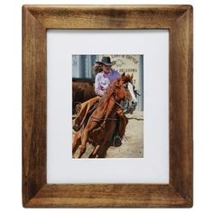 a man riding on the back of a brown horse