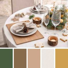 the table is set for christmas dinner with wine glasses, cookies and other holiday decorations