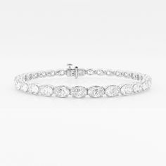 Elegant and yet unique, oval shaped diamonds are stylishly set in an east-west pattern in this beautiful tennis bracelet. Lab grown diamonds, as unique as you, glisten through this gorgeous setting, making the light dance to your tunes. Luxury Oval Diamond White Diamond Bracelet, Oval Diamond Bracelet For Anniversaries, Luxury Diamond White Oval Diamond Bracelet, Oval Diamond White Bracelet With Diamond Accents, Oval White Gold Diamond Bracelet With Diamond Accents, Luxury Oval Tennis Bracelet With Diamond Accents, Oval Brilliant Cut Diamond Bracelet For Anniversary, Classic Oval Diamond Bracelet With Accents, Brilliant Cut Oval Diamond Bracelet For Anniversary