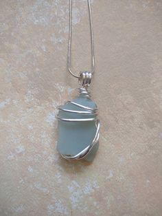 Handpicked, handmade silver plated wire wrapped sea glass pendant. Wire Wrapped Silver Recycled Glass Jewelry, Wire Wrapped Silver Jewelry With Recycled Glass, Silver Wire-wrapped Necklace With Recycled Glass, Silver Wire Wrapped Necklace With Recycled Glass, Wire Wrapped Silver Sea Glass Necklaces, Wire Wrapped Silver Necklace With Sea Glass, Silver Sea Glass Necklace With Wire Wrapped Detail, Sea Glass Pendant, Glass Pendant